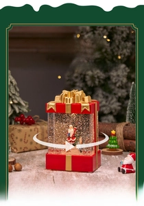 Detail of Santa Claus snow globe gift box with rotating light and swirling glitter effect