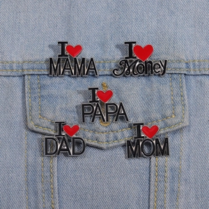 Cartoon enamel heart badges with I Love Mom Dad Money text pinned on denim jacket