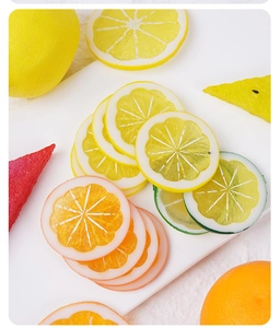 Macro shot of realistic PVC lemon, lime, orange, and watermelon slices photography props