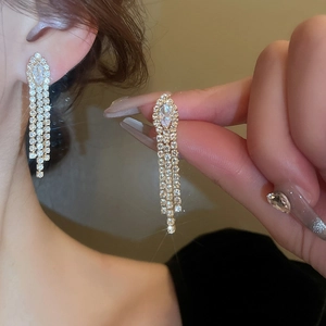 Detailed view of luxury long zircon tassel earrings showing elegant cascading rhinestone fringe