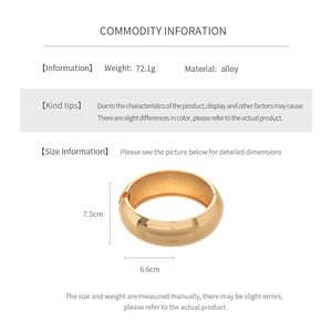 Detailed view of wide gold alloy cuff bracelet with polished surface and 7.5cm height