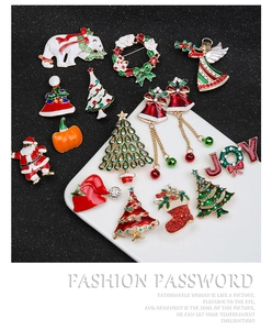 Detailed view of colorful Christmas brooches featuring Santa and tree with rhinestone accents