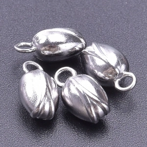 Macro view of 4 silver stainless steel flower bud pendants for DIY jewelry making