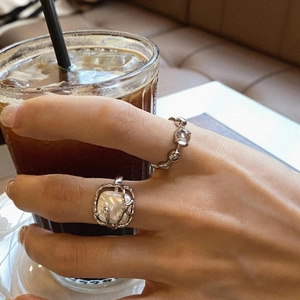 Retro Baroque pearl and zircon silver rings shown on hand holding an iced coffee cup