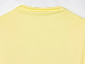 Detail of the back neckline and layered fabric texture on a yellow knit maxi dress