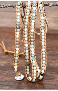 Detailed view of bohemian multi-layer wrap bracelet with natural stones and leather cord
