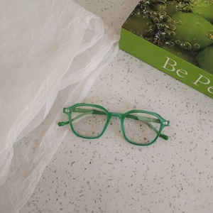 Top view of translucent green acetate frames for kids with metal dot details