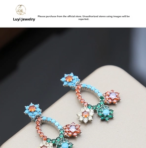 Macro shot of colorful floral earrings with vibrant zircon stones in luxury detail