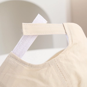 Detail of adjustable Velcro strap on a breathable beige quick-dry baby sun hat
