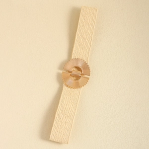 Close-up of beige elastic woven waist belt featuring a gold circular metal buckle detail