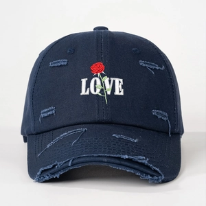 Distressed navy baseball cap with embroidered rose and LOVE text on white background