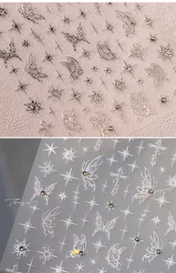 Macro detail of 3D embossed butterfly and star nail art stickers with metallic finish