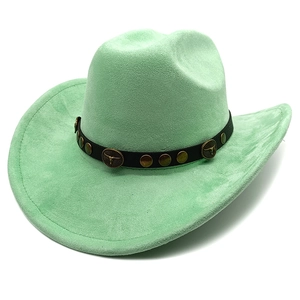 Detail of mint green suede cowboy hat featuring vintage bull head studs and leather band