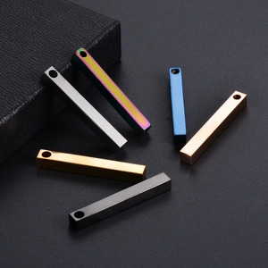 Polished rectangular stainless steel pillar pendants in five colors on textured background