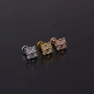 Detail of 16G stainless steel labret studs with snowflake zircon in silver, gold, and rose gold