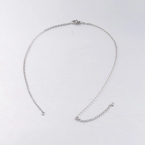 Detailed view of silver stainless steel 2mm cross chain with lobster clasp and extender