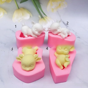 Macro view of four 3D sleeping deer silicone molds for cake toppers and DIY resin crafts