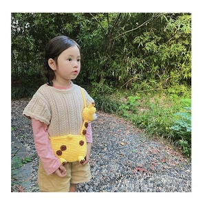 Detail of cute yellow knit giraffe cross-body bag for little girls with 3D animal design