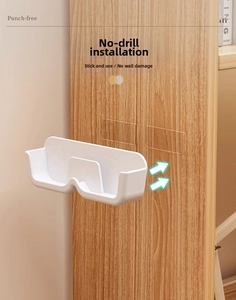 Close-up of a white wall-mounted storage box with transparent adhesive pads for glasses
