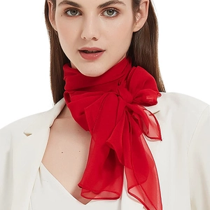 Elegant red chiffon long scarf tied as a large bow on white blazer outfit