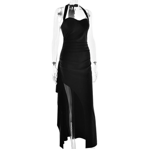 Detail view of a black halter maxi dress with slim fit cut and high side slit design