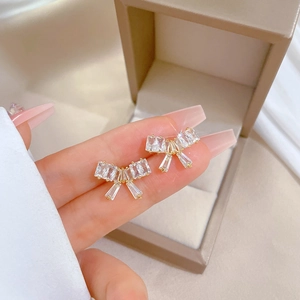 Elegant titanium steel bow earrings with sparkling zirconia in a luxury jewelry gift box