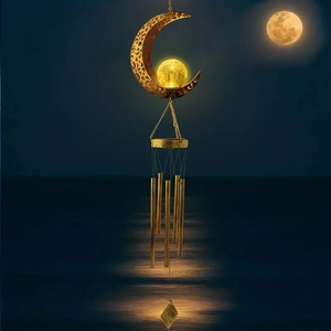 Solar powered moon wind chime light with hollow iron design and glowing crystal ball