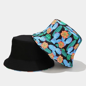 Detail of reversible sun hat showing black side and colorful cactus floral print texture
