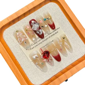 Handmade 3D Christmas press-on nails featuring red rhinestones and relief tree patterns