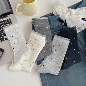 Five pairs of bamboo fiber crew socks with polka dots and lace trim in assorted colors