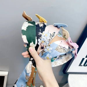 Close-up of assorted floral bow headbands in various colors with a soft fabric texture