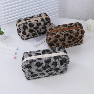 Three leopard print plush cosmetic bags in white, brown and grey with zip closure