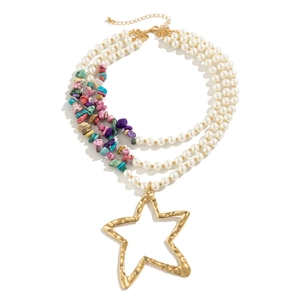 Detailed macro view of triple-layered faux pearl and colorful gemstone star necklace