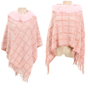 Close-up of pink knit chenille poncho featuring a faux fur collar and fringed hem design