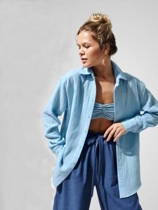 Texture detail of light blue cotton crepe shirt and dark blue drawstring wide-leg pants
