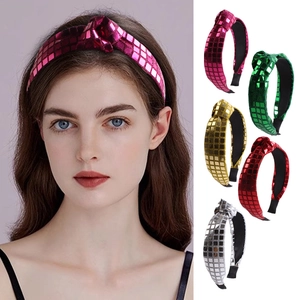 Detail of sequin fabric knotted headbands in pink, green, gold, red and silver colors