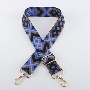 Detail of adjustable blue and grey geometric woven strap with gold metal lobster clasp