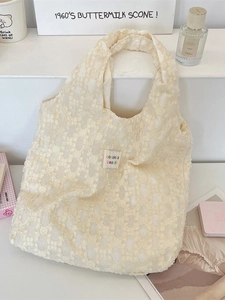 Elegant off-white knit tote bag featuring 3D floral lace and minimalist handle design