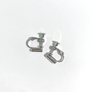 Close-up of silver screw-back earring converters for non-pierced ears on white background
