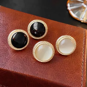Vintage round cat-eye stone earrings in black and white with gold twist frames