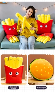 Macro shot of creative french fries plush pillows and round hamburger soft toy