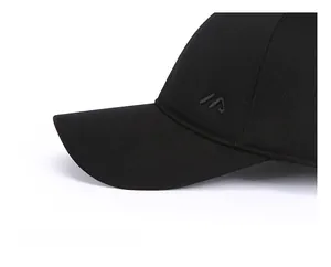 Detailed close-up of the reinforced thick brim and embroidered logo on a black winter baseball cap