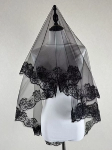 Detailed close-up of double-layer black bridal veil with wide floral lace embroidery edge