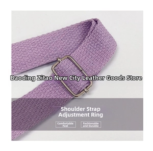 Detail of adjustable silver buckle on purple corduroy shoulder strap with woven texture