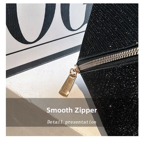 Close-up of black glitter fabric vanity bag with premium smooth golden metal zipper