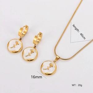Elegant gold necklace and earring set with white shell inlay and rose flower charms