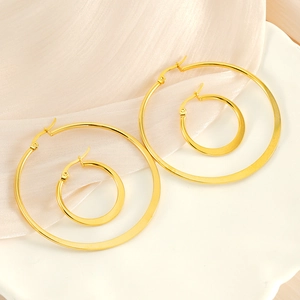 Polished 18K gold plated stainless steel hoop earrings in two sizes on silk fabric