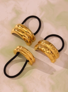 Detailed view of three 18K gold-plated stainless steel hair ties with smooth and hammered textures
