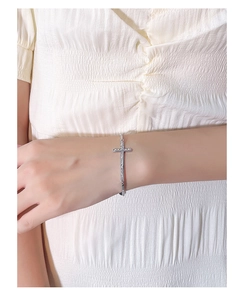 Elegant 925 sterling silver cross bracelet on woman wrist with textured chain detailing