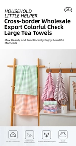 Macro view of multi-color plaid cotton tea towels hanging on a wooden ladder rack